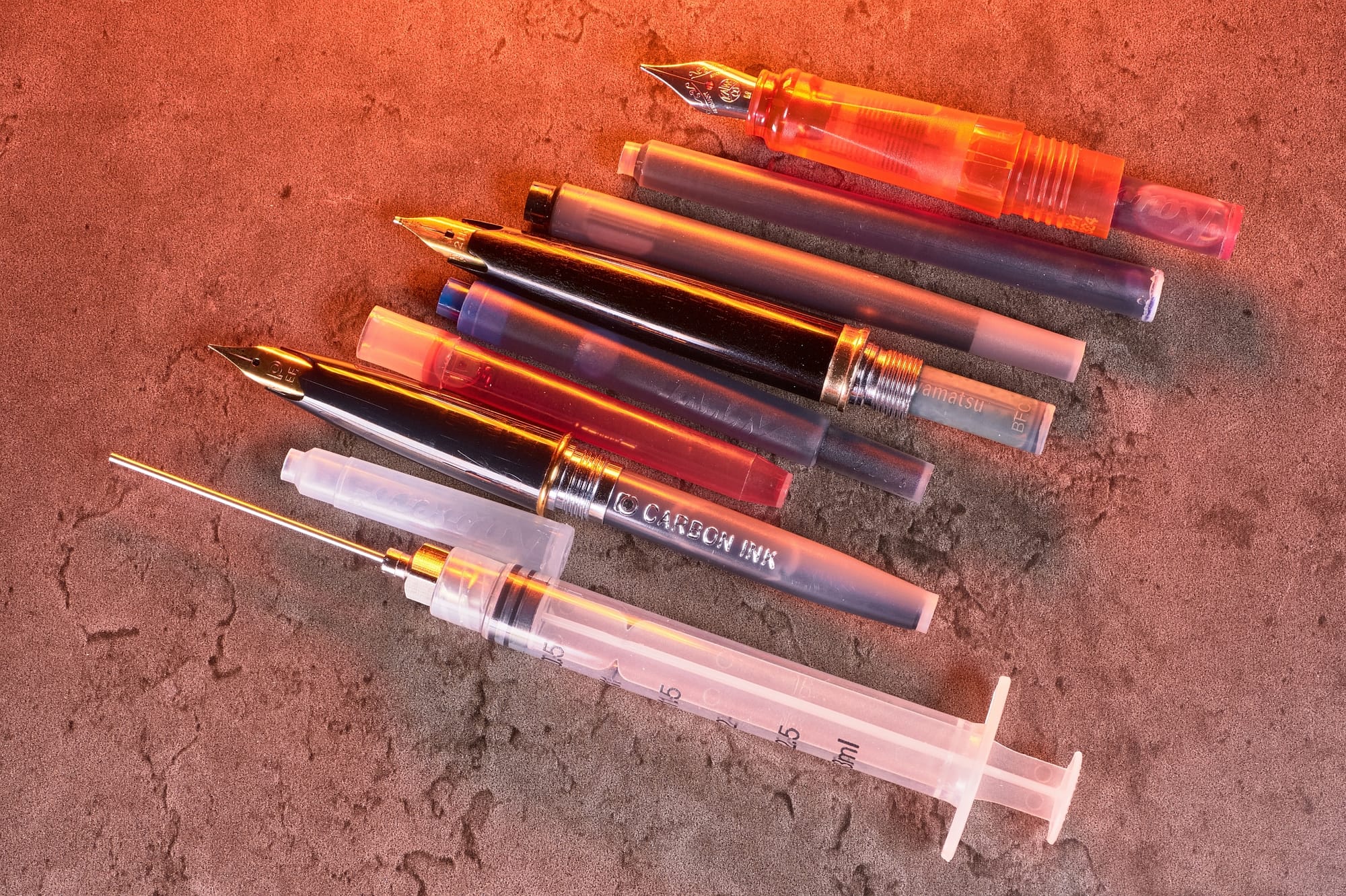 Photo of 3 fountain pens with cartridges installed.